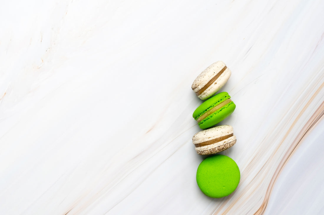 two green and two brown macarons