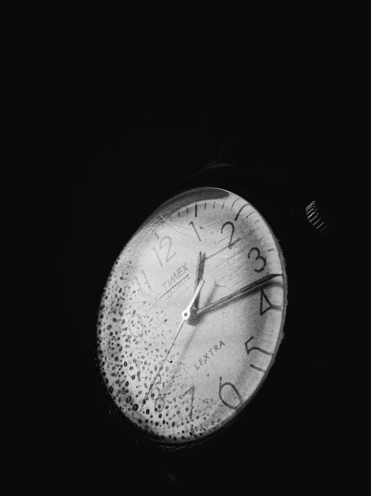 a black and white photo of a clock