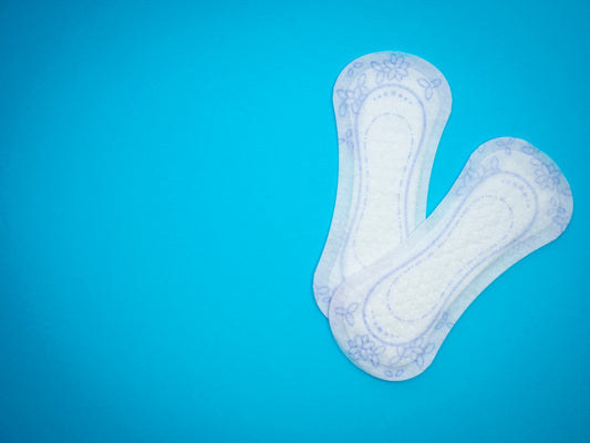 a pair of sanitary pads sitting on top of a blue surface