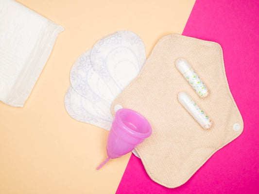 a pink and yellow table topped with a baby bottle and a diaper