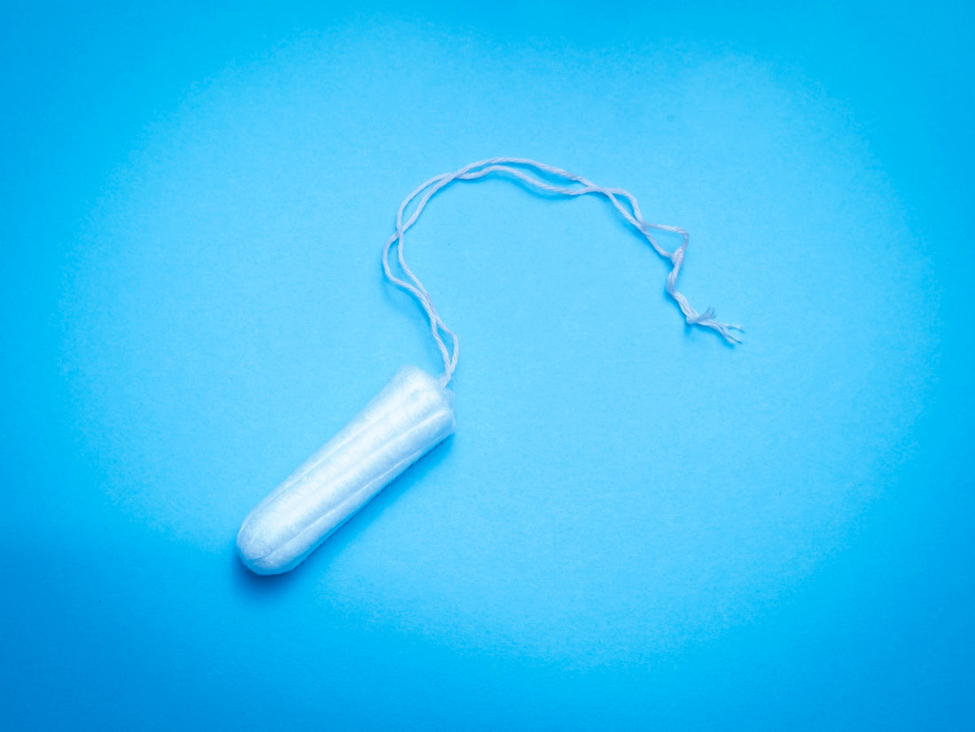 a plastic tube of toothpaste on a blue background