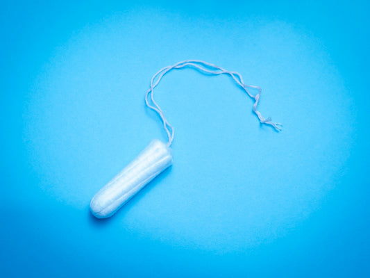 a plastic tube of toothpaste on a blue background