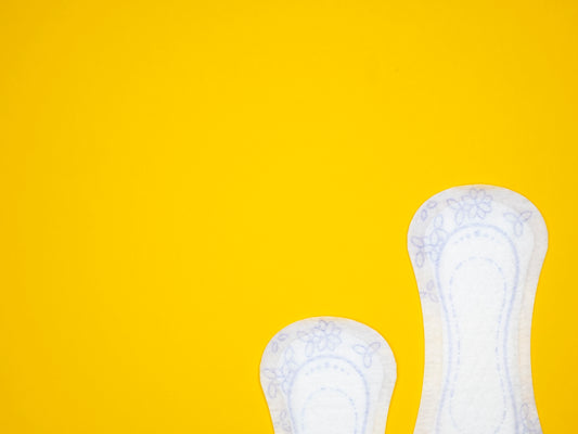 a pair of white shoes on a yellow background