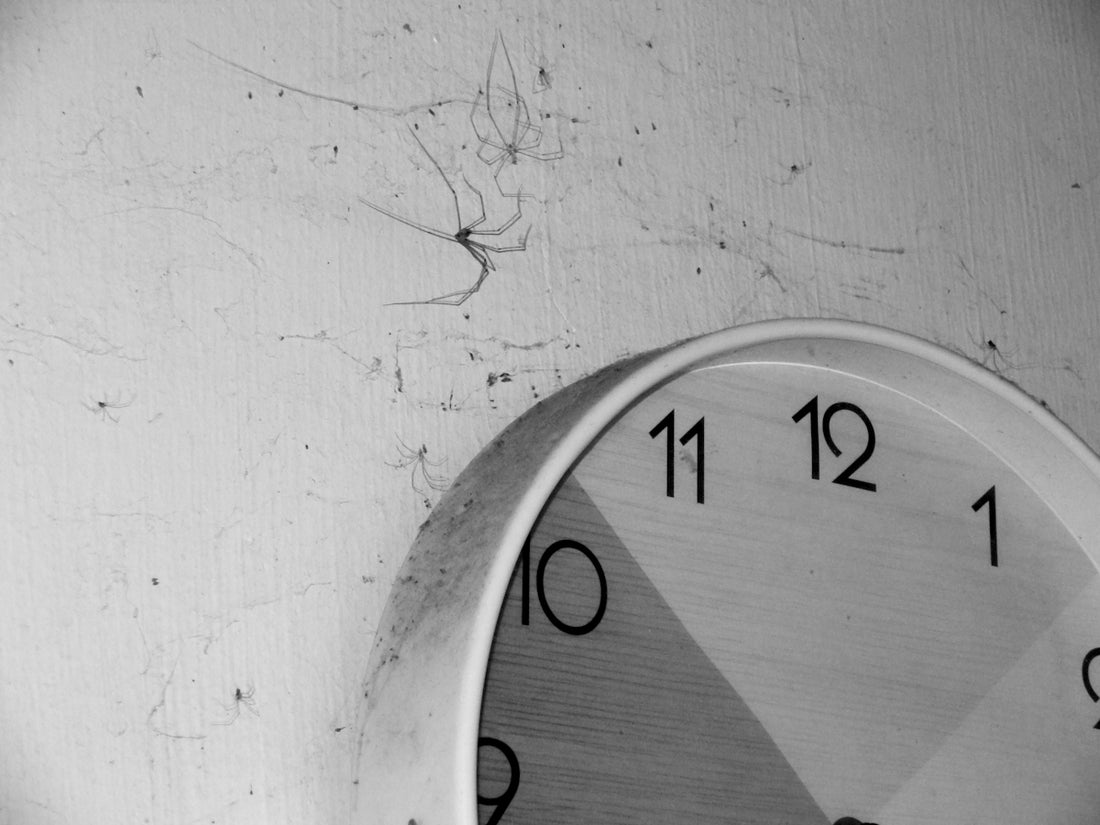 A black and white photo of a clock on a wall