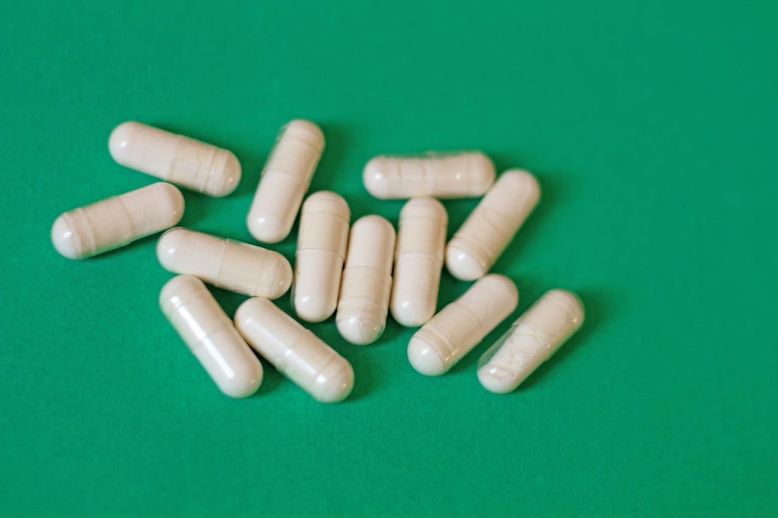 A pile of pills sitting on top of a green table