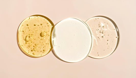 Three swirls of cosmetic liquid are displayed.