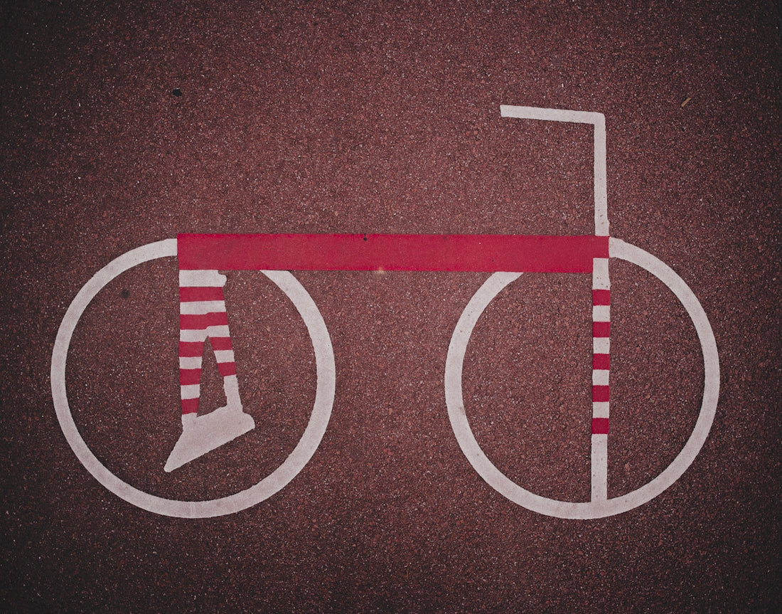 Stylized bicycle with striped wheels and frame.